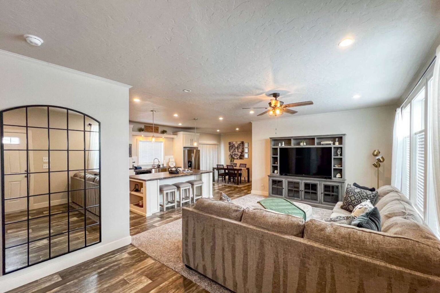 Spacious interior of a manufactured home showing living room and kitchen